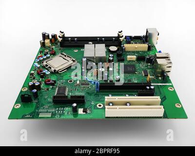 High resolution image of a computer motherboard removed from a computer isolated against a white background. Stock Photo