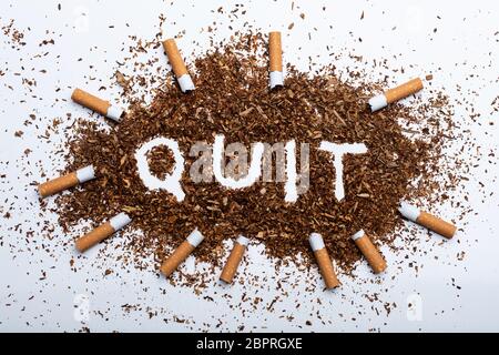An Elevated View Of Frame Made With Broken Cigarettes Around Quit Word Written On Tobacco Stock Photo