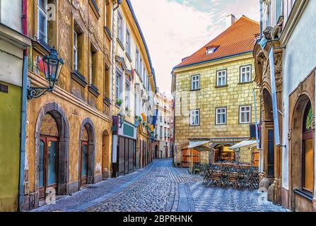 Prague Street in Old town and a street restaurant, no people. Stock Photo