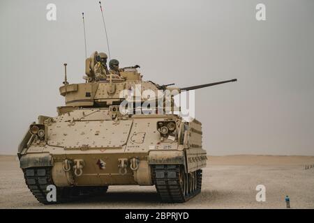 U.S. Soldiers with the 1-150th Cavalry Regiment, deployed from the West Virginia National Guard, stage their Bradley Fighting Vehicle for live-fire training May 4, 2020 in the U.S. Army Central region. The unit conducts ranges to maintain battlefield capabilities including reconnaissance, fire and maneuver, and “hunter-killer” engagement. (U.S. Army photo by Sgt. Angela O’Hearn) Stock Photo