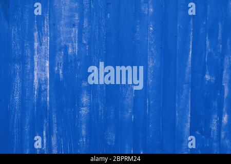 Abstract background texture of blue painted vivid metal wall surface with uneven grunge paint strokes, close up Stock Photo