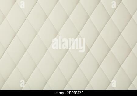 Background texture of white leather soft tufted furniture or wall panel upholstery with deep diamond pattern, close up Stock Photo