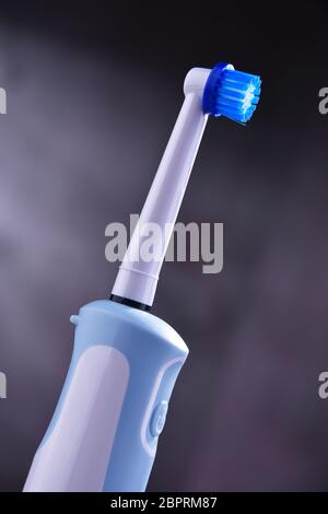 Modern electric toothbrush powered by rechargeable battery. Stock Photo