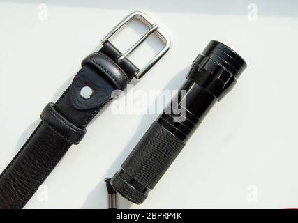 Men's accessories black leather strap and flashlight isolated on white background. Stock Photo