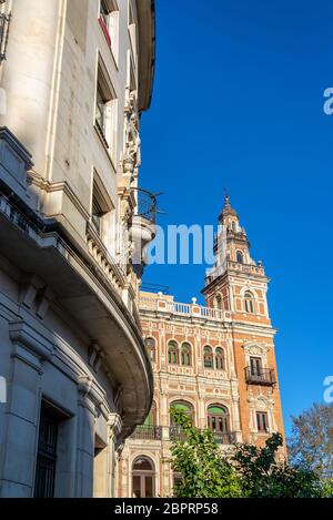 Early morning light falling on an ornate historic building in the center of Seville, Spain Stock Photo