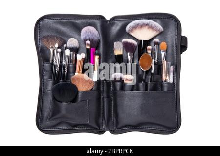 Professional brushes. Professional collection set of various makeup brushes cosmetic in a black leather case isolated on a white background. Beauty co Stock Photo