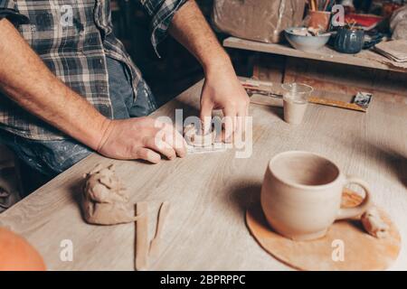 Process of creating a clay cup in pottery workshop Stock Photo
