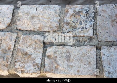 Close-up of natural stone tiles joined by cements that are part of a wall Stock Photo