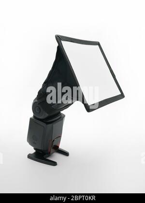 External speedlight with and diffuser isolated on white background Stock Photo