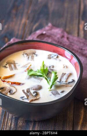 Bowls of thai tom kha soup on the wooden table Stock Photo