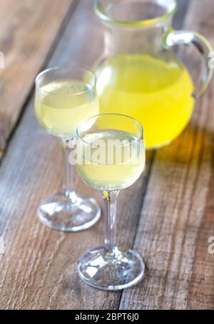 Two glasses of limoncello on the wooden background Stock Photo
