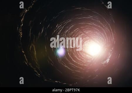 Inside old red brick tube with ladder. Stock Photo