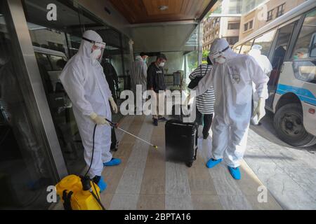 Beirut, Lebanon. 19th May, 2020. A worker disinfects a suitcase belonging to a person returning from abroad in front of a hotel in Beirut, Lebanon, on May 19, 2020. Lebanon's number of COVID-19 infections increased on Tuesday by 23 cases to 954, while the death toll remained unchanged at 26, the National News Agency reported. Credit: Bilal Jawich/Xinhua/Alamy Live News Stock Photo