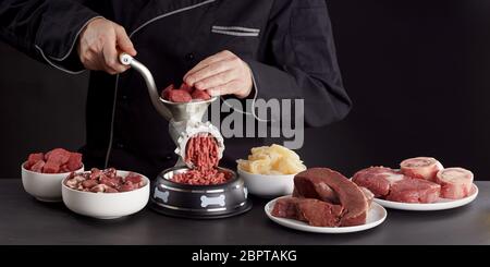 Preparing fresh raw meat for barf dog food with a mix of poultry