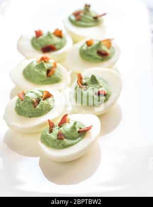 Spinach and bacon deviled eggs Stock Photo