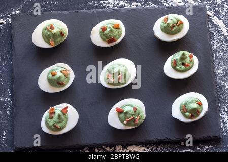 Spinach and bacon deviled eggs Stock Photo