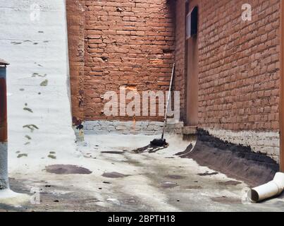 Roof repair on a old commercial building Stock Photo