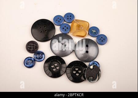 Several multi-colored buttons of different sizes on a white background. Close up Stock Photo