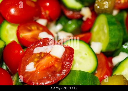 Vegetable salad sliced tomatoes, cucumbers, onions and pickles. Close up. Healthy food, fitness diet Stock Photo