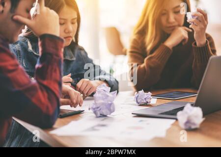 Three businessman get stressed while having a problem in business meeting Stock Photo