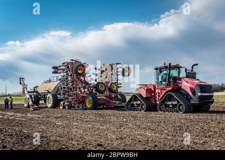 Swift Current, SK/Canada- May 15, 2020: Farmers consulting after loading seed and fertilizer into the Bourgault air seeder in Saskatchewan, Canada Stock Photo