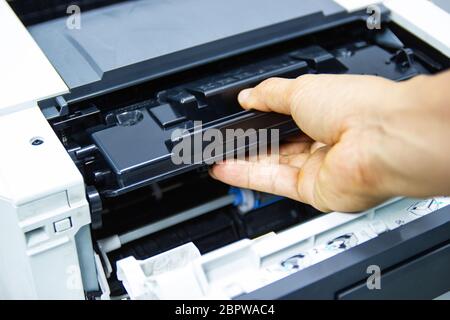 Technicians replacing toner in laser printer concept office supplies repair Stock Photo