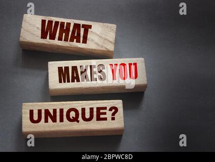 What makes yiu unique - phrase on Wooden blocks. Business or carees success concept
