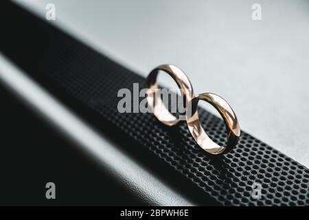 Close up of wedding rings on a black leather belt Stock Photo