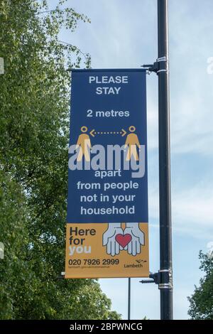 West Norwood, UK. 15th May, 2020. A social distancing advice sign hanging from a lamppost in West Norwood in South London. photo by Sam Mellish Stock Photo