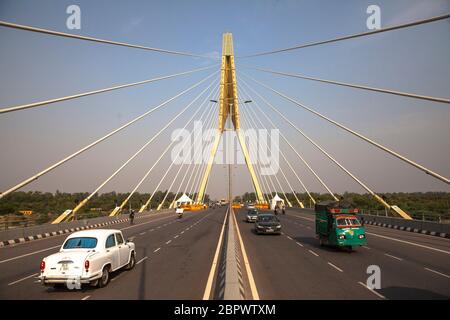 Vehicles drive on the signature bridge, as the country relaxed its lockdown restriction on May 14, 2020 in New Delhi, India. India has relaxed its lockdown restrictions even as the pace of infection has picked up. The COVID-19 disease is spreading at a worrying rate in the country and the death toll in India due to coronavirus stands at 2,564, but despite the grim statistics India has allowed most businesses and services to reopen. India was under a strict lockdown from March 25. Photographer: Kuldeep Singh Rohilla Stock Photo