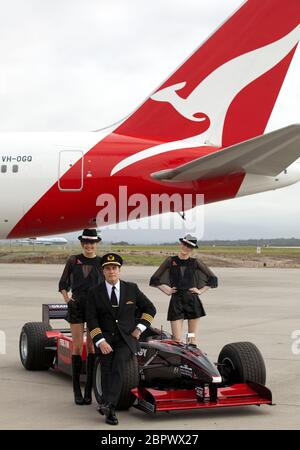 John Travolta with models and wearing Qantas pilot's uniform, Melbourne airport, 2010. Stock Photo
