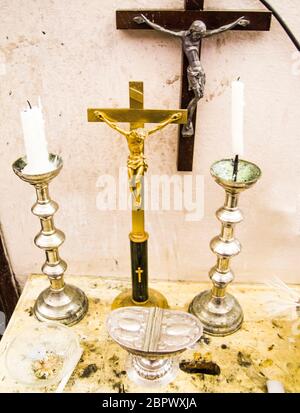 in the old parsonage there are old crucifixes, candles, incense and holy water, pronouns for holy mass Stock Photo