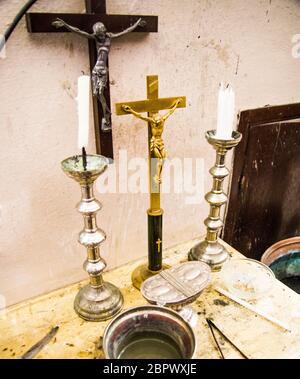 in the old parsonage there are old crucifixes, candles, incense and holy water, pronouns for holy mass Stock Photo