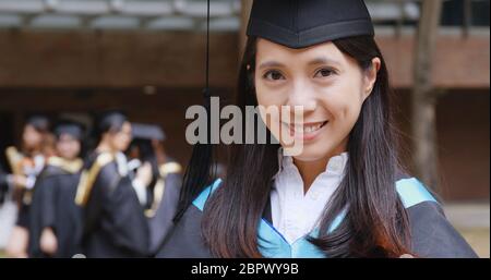 Woman smile to camera in university campus for graduation ceremony Stock Photo