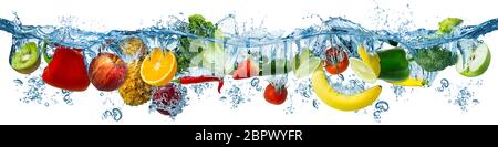 fresh multi fruits and vegetables splashing into blue clear water splash healthy food diet freshness concept isolated on white background Stock Photo