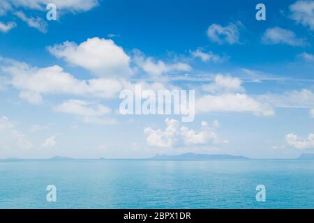 White fluffy clouds and turquoise sea on blue sky Stock Photo
