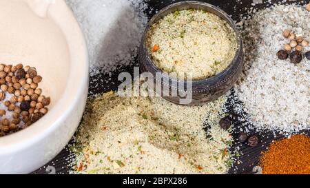 salt cellar and various Seasoned Salts with ingredients on dark wooden table Stock Photo