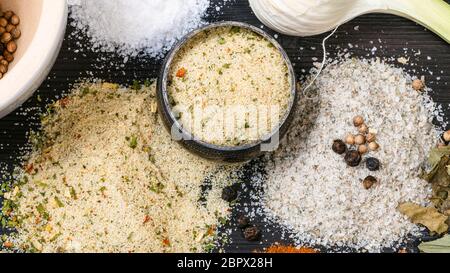 top view of salt cellar and various Seasoned Salts with ingredients on dark wooden table Stock Photo