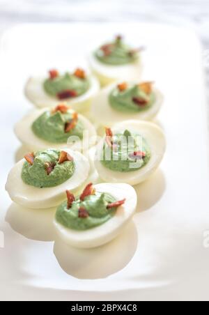 Spinach and bacon deviled eggs Stock Photo