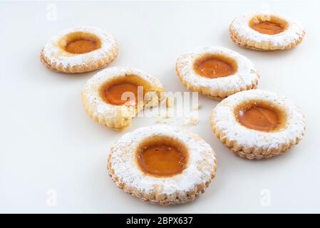 round pastries of pastry and jam on a white surface Stock Photo