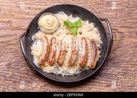 grilled nuremberger bratwurst with sauerkraut Stock Photo