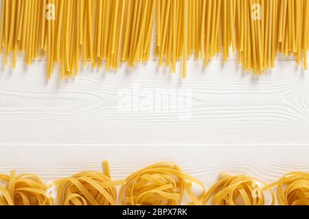 Mixed dried pasta selection on wooden background. Top view. Copy space. Stock Photo