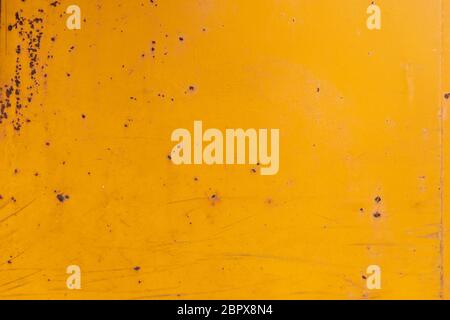 Yellow painted old rusty metal surface. An oxidized weathered surface with paint on it and a vintage texture and structure. Material effect Stock Photo