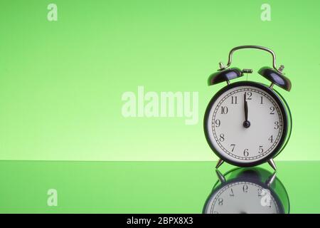 Alarm Clock on green background with selective focus and crop fragment. Copy space and business concept Stock Photo