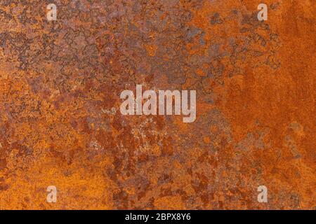 Orange textured old rusty metal surface. An weathered oxidized patina with a copper color, texture and structure. Vintage material effect Stock Photo