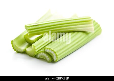 Celery sticks. Cutting celery stalks isolated on white background. Stock Photo
