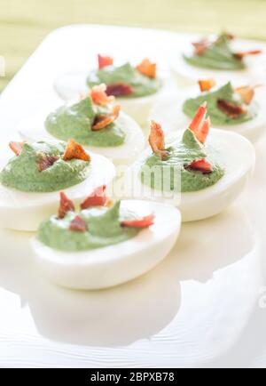 Spinach and bacon deviled eggs Stock Photo