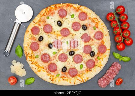 Pizza pepperoni salami from above baking ingredients on a slate Stock Photo