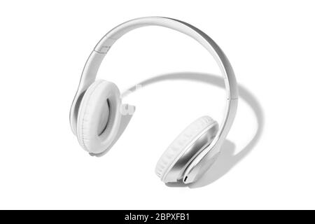 Wireless white headphones isolated on a white studio background with copyspace. Modern bluetooth technologies, music portable and entertainment equipment. Accessory for recording and listening. Stock Photo