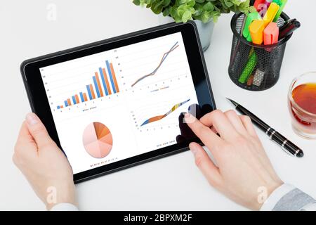 Data analysis concept shown on a tablet held by a woman Stock Photo